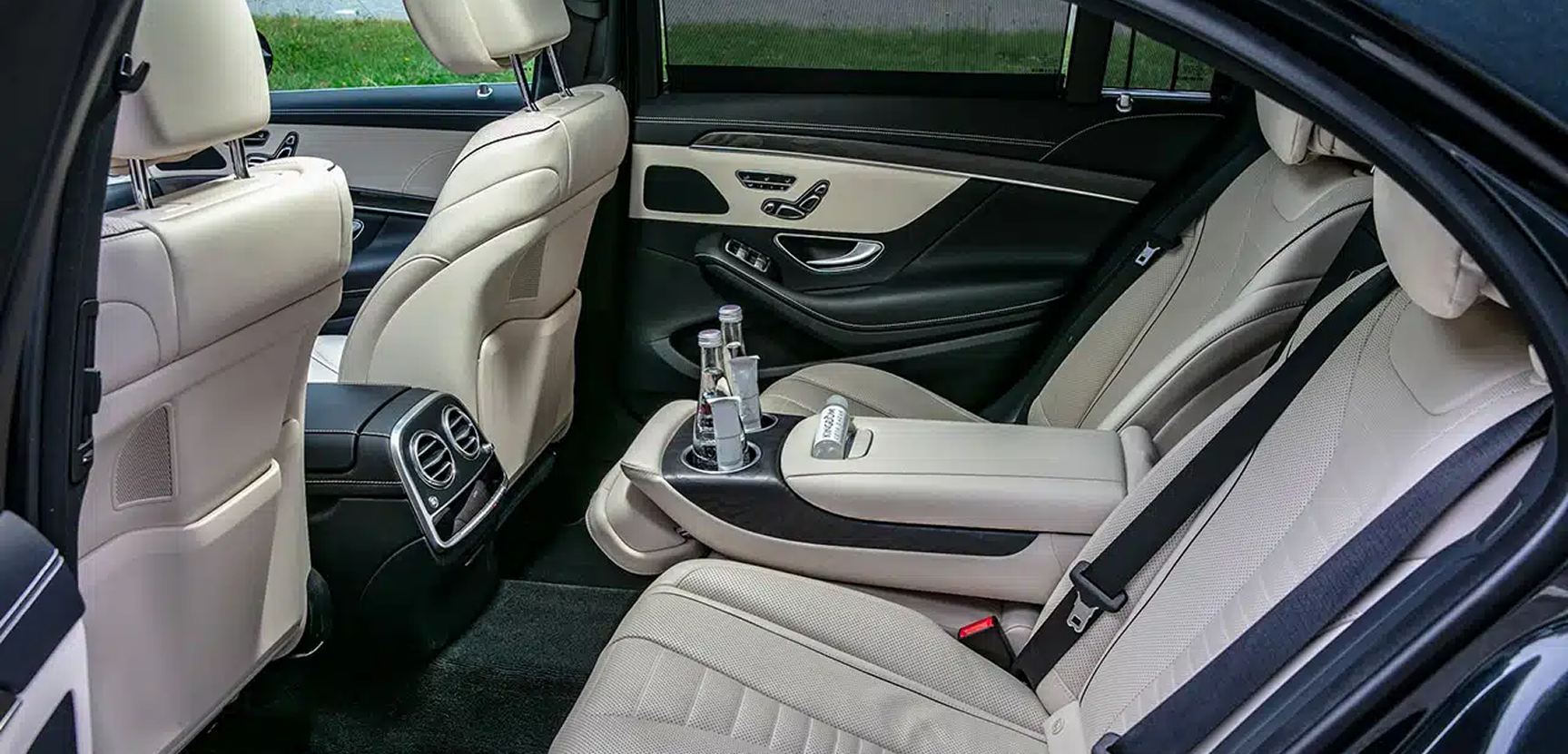 The rear seat of a chauffeured sedan